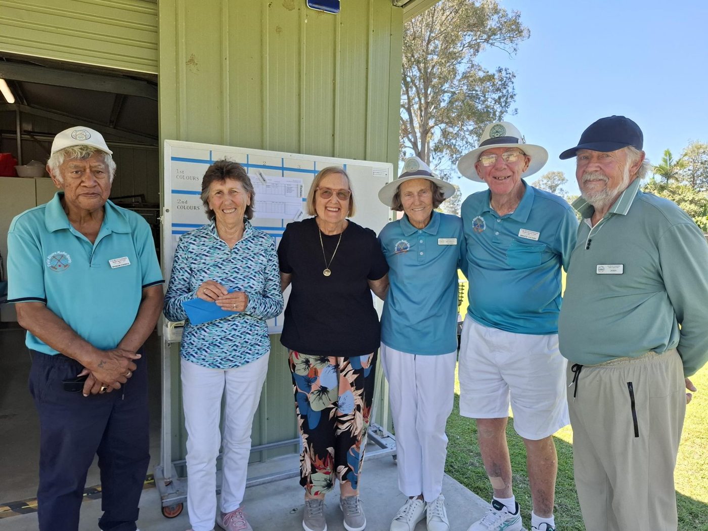 Six Twin Rivers members in club shirts stand together outside the clubhouse at the 2026 Club Singles Championship.