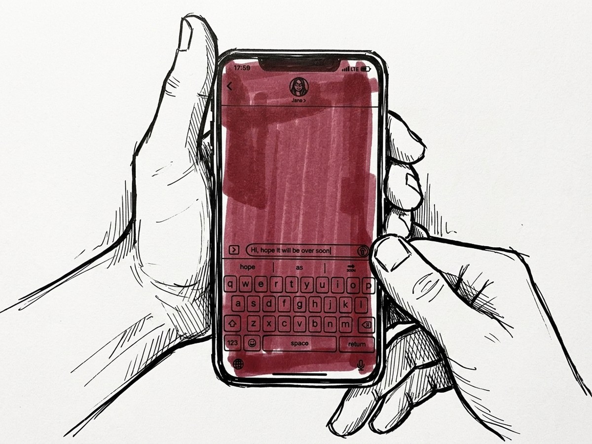 Two hands holding a phone, thumbs over the on-screen keyboard.
