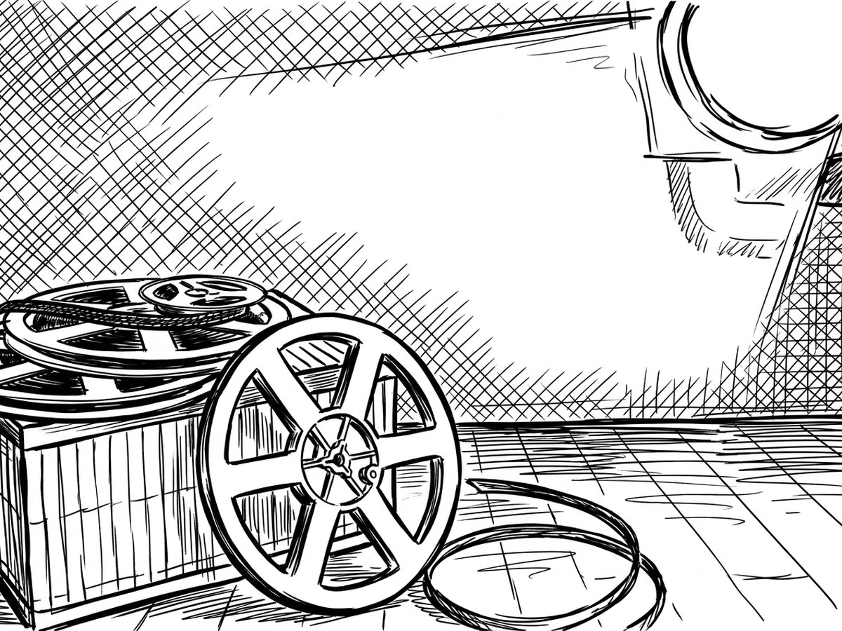 A film reel and spare rings resting on a wooden floor.