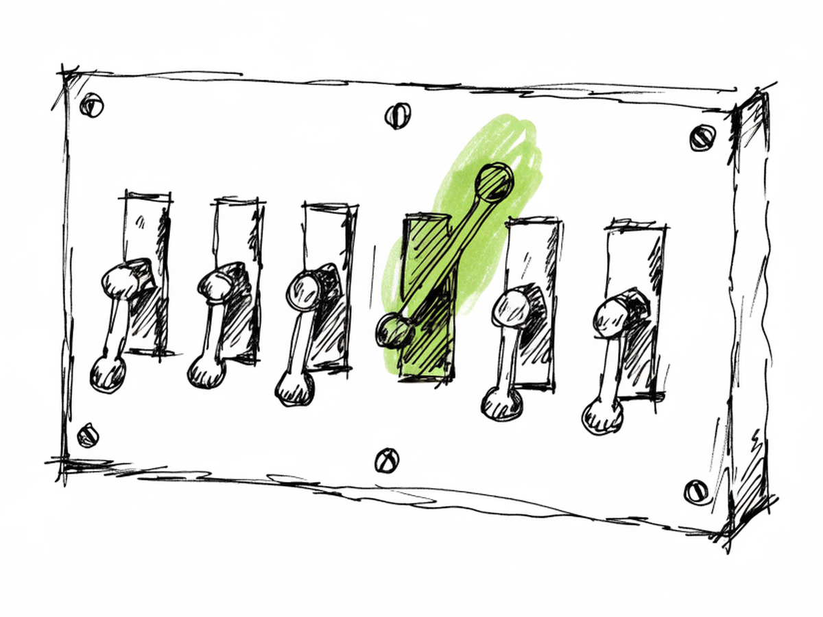 A row of brass toggle light switches on a wall plate, one switch flicked on.